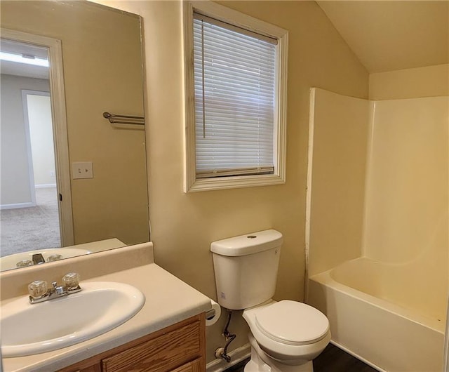 full bathroom featuring lofted ceiling, toilet,  shower combination, and vanity