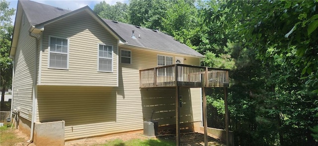 back of house with a balcony and central air condition unit