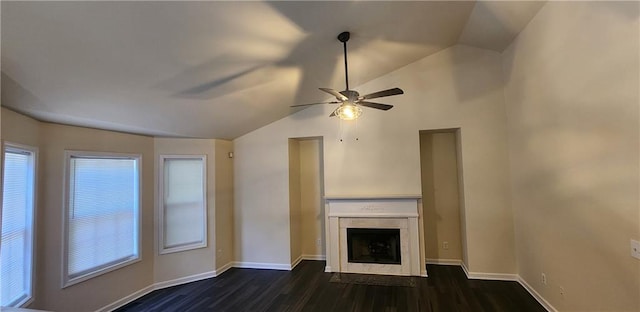 unfurnished living room featuring lofted ceiling, dark wood-type flooring, a premium fireplace, and ceiling fan