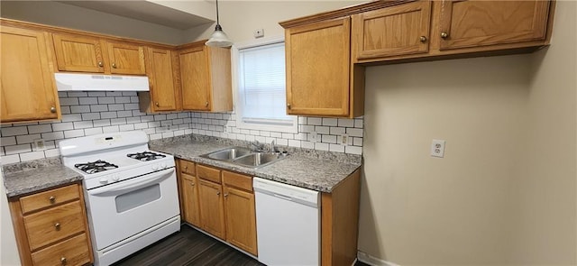 kitchen with tasteful backsplash, sink, white appliances, and decorative light fixtures