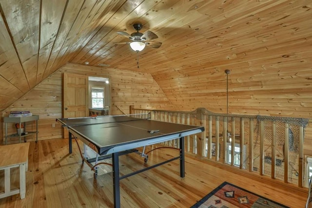 rec room featuring vaulted ceiling, wood walls, wooden ceiling, and hardwood / wood-style floors