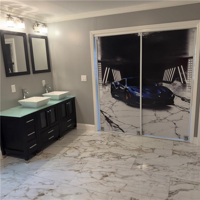 full bathroom with ornamental molding, marble finish floor, a sink, and double vanity