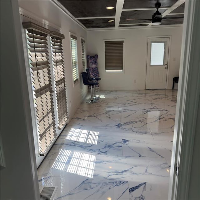 empty room featuring a ceiling fan, marble finish floor, and coffered ceiling