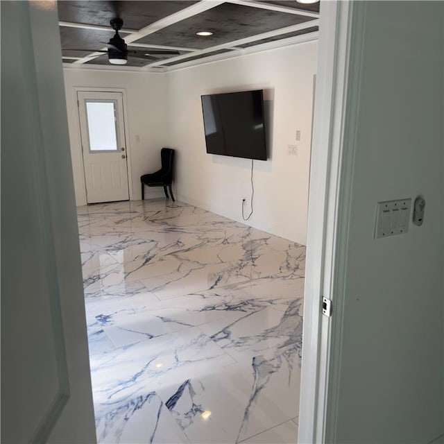 living area featuring a ceiling fan and marble finish floor