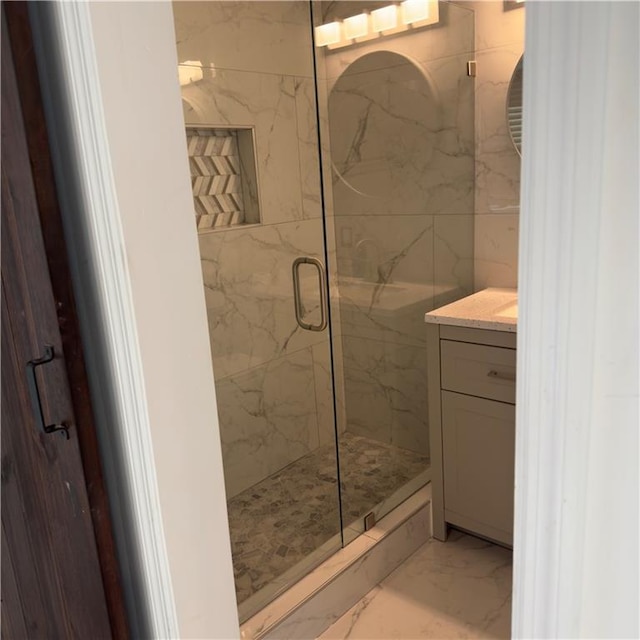 bathroom featuring marble finish floor, vanity, and a marble finish shower