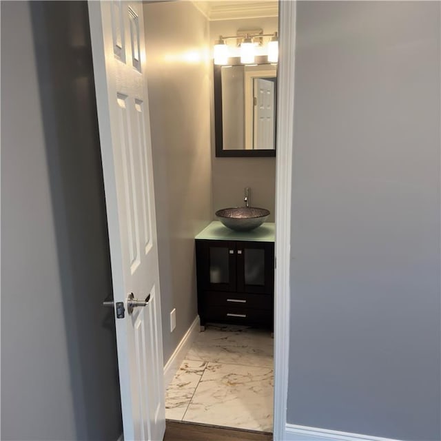 bathroom featuring marble finish floor, vanity, and baseboards