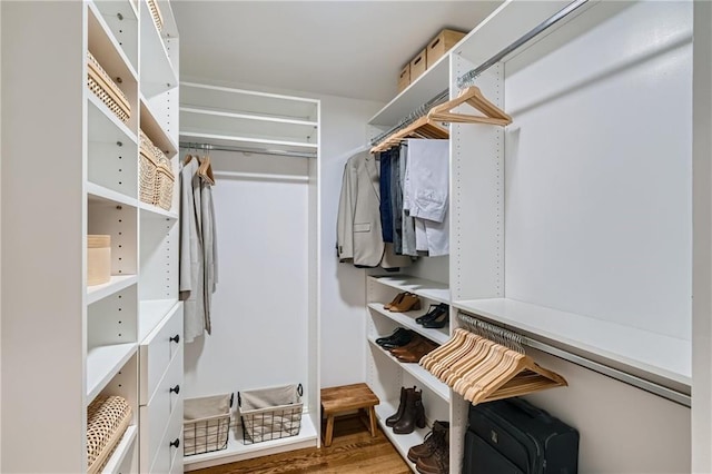 walk in closet with hardwood / wood-style flooring