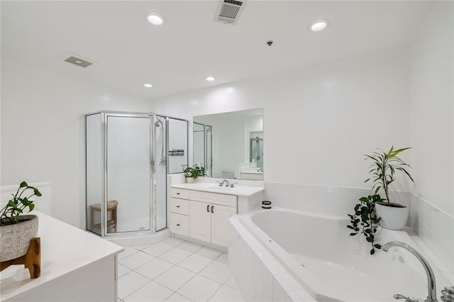 bathroom with tile patterned floors, independent shower and bath, and vanity