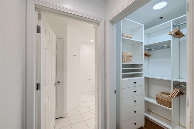 spacious closet with light tile patterned floors