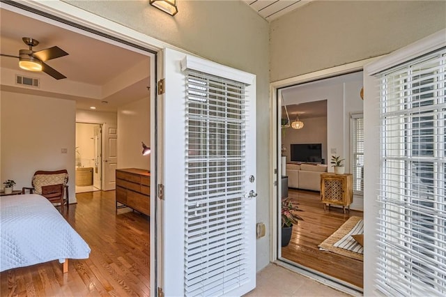 bedroom featuring hardwood / wood-style floors and connected bathroom