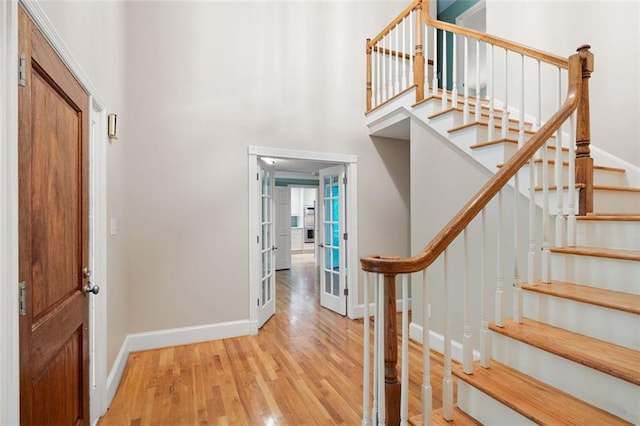 465 Willowbrook Dr SE, Smyrna, GA 30082 - foyer entrance with wood finished floors, baseboards, stairway, french doors, and a towering ceiling