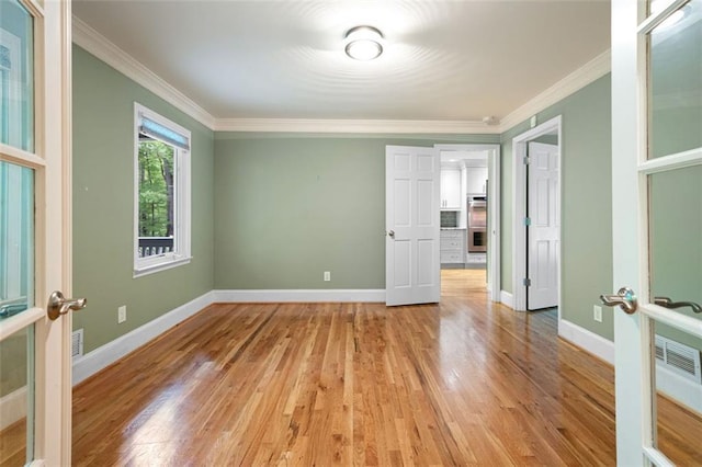 465 Willowbrook Dr SE, Smyrna, GA 30082 - empty room featuring light wood-style flooring, french doors, crown molding, and baseboards