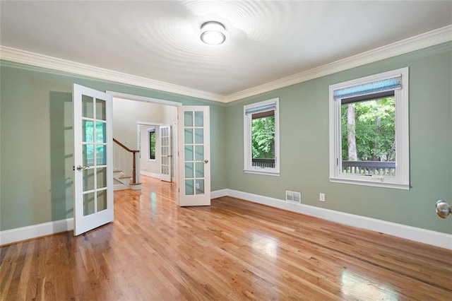 465 Willowbrook Dr SE, Smyrna, GA 30082 - spare room featuring french doors, crown molding, baseboards, wood finished floors, and stairway