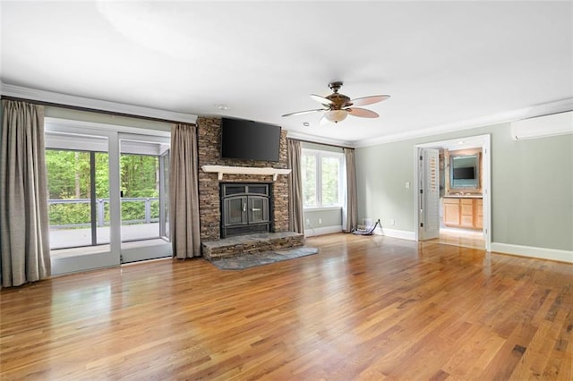 465 Willowbrook Dr SE, Smyrna, GA 30082 - unfurnished living room with an AC wall unit, ceiling fan, a fireplace, light wood finished floors, and baseboards