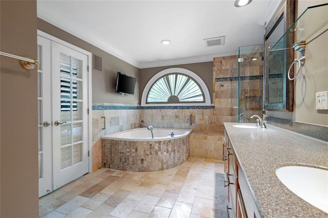 465 Willowbrook Dr SE, Smyrna, GA 30082 - bathroom featuring a bath, double vanity, crown molding, and recessed lighting
