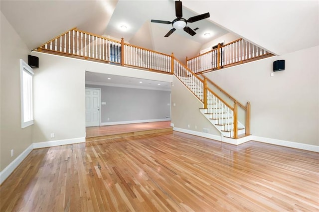 465 Willowbrook Dr SE, Smyrna, GA 30082 - unfurnished living room with high vaulted ceiling, a ceiling fan, wood finished floors, baseboards, and stairway