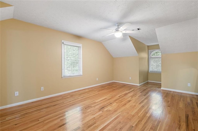 465 Willowbrook Dr SE, Smyrna, GA 30082 - bonus room featuring vaulted ceiling, a ceiling fan, a textured ceiling, healthy amount of natural light, and light wood-style flooring