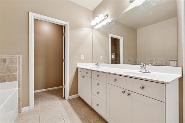 bathroom featuring tile patterned flooring, a bath, and vanity