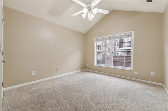 carpeted empty room with ceiling fan and lofted ceiling