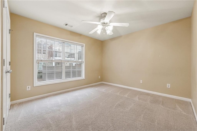 carpeted empty room featuring ceiling fan