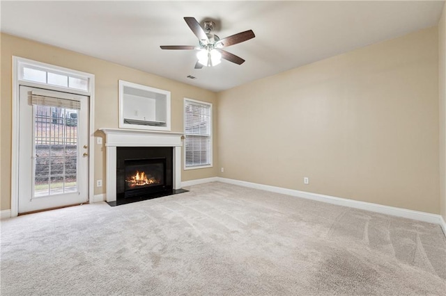 unfurnished living room featuring light carpet and ceiling fan