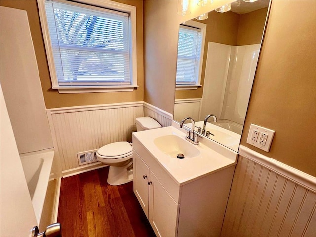 bathroom with wood-type flooring, vanity, and toilet