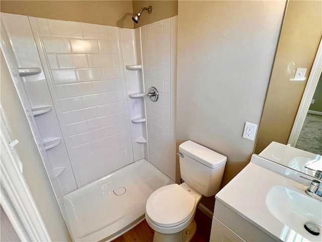 bathroom featuring a shower, vanity, and toilet