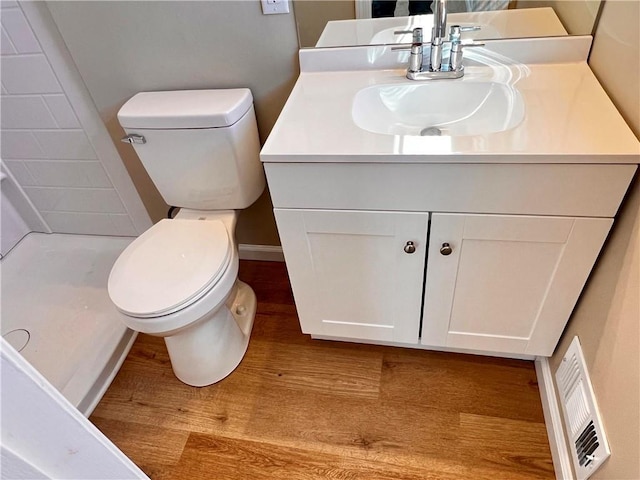 bathroom featuring vanity, toilet, and wood-type flooring