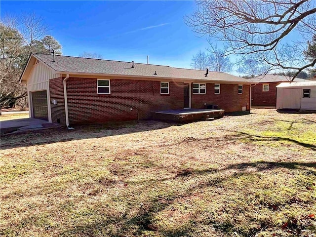 back of house featuring a patio, a garage, and a storage unit