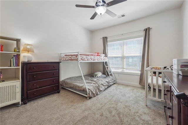 bedroom featuring ceiling fan and light carpet