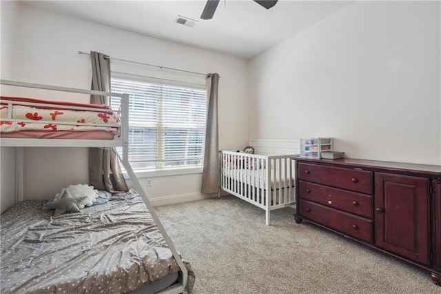 bedroom featuring ceiling fan and light carpet