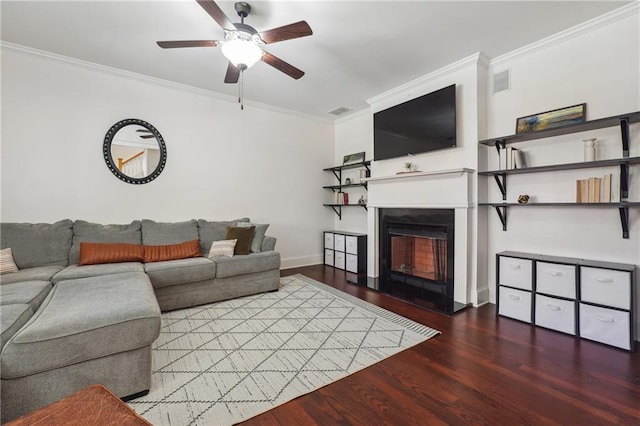 living room with dark hardwood / wood-style floors, ceiling fan, and crown molding