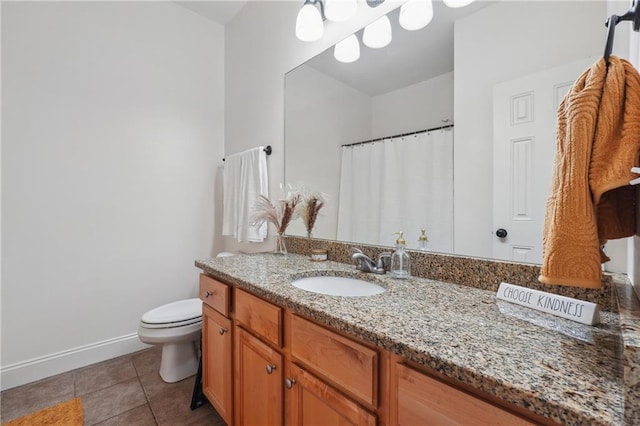 bathroom featuring tile patterned flooring, vanity, and toilet