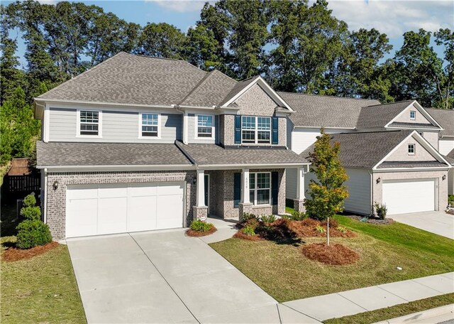 craftsman-style house with a front yard and a garage