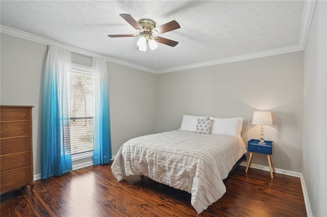 bedroom with ornamental molding, baseboards, and wood finished floors