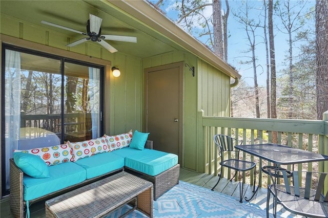 wooden deck with a ceiling fan