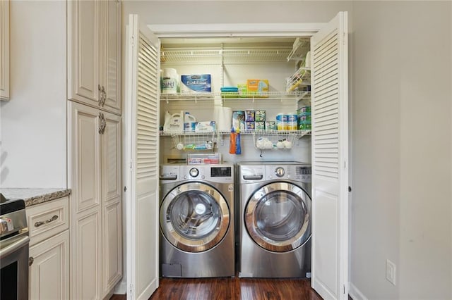 washroom with dark wood-style floors, laundry area, and washer and dryer