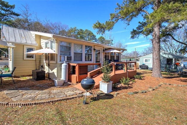 back of house with a yard and a deck