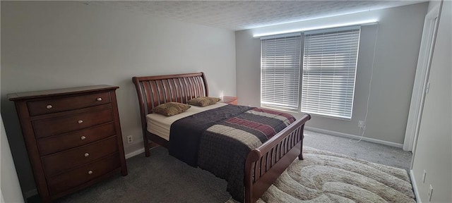 carpeted bedroom with a textured ceiling and baseboards