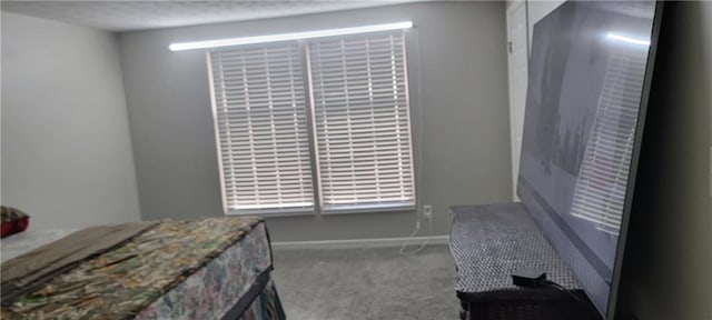 carpeted bedroom featuring baseboards