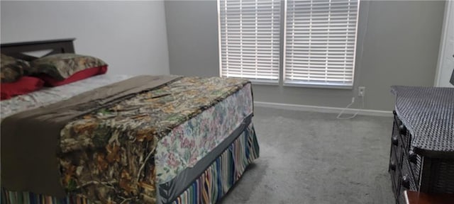 bedroom with carpet flooring and baseboards