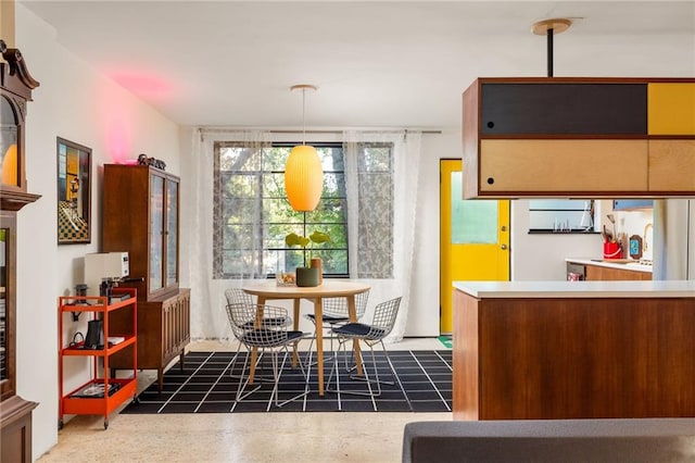 dining space featuring speckled floor