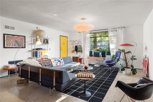 living area with speckled floor and visible vents