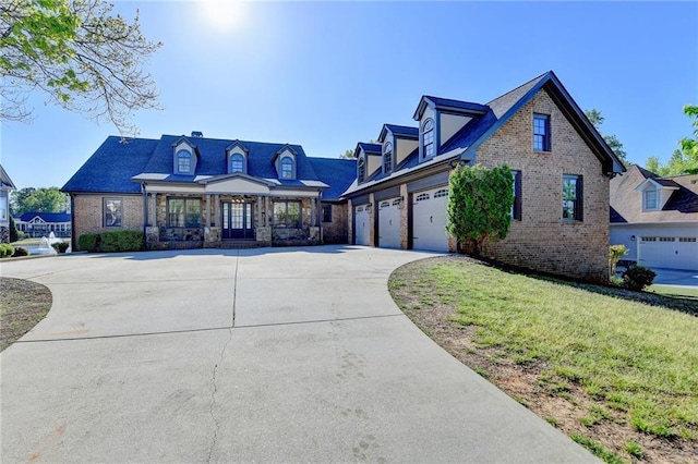 view of front of property with a garage, concrete driveway, a front lawn, and brick siding