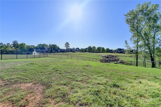 view of yard featuring fence and a rural view
