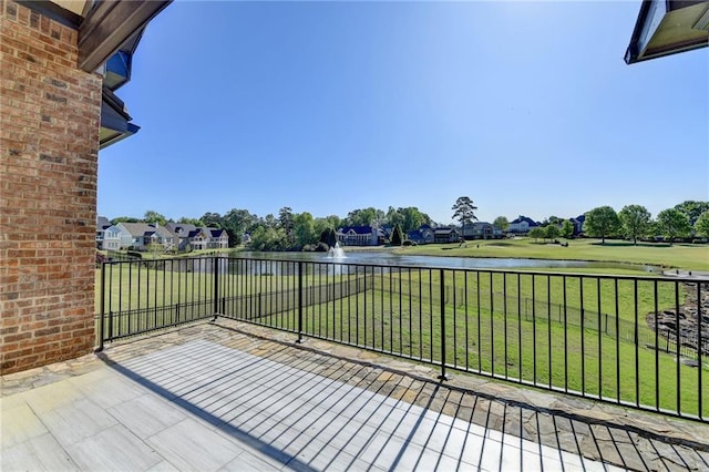 exterior space with a yard, a water view, and a residential view