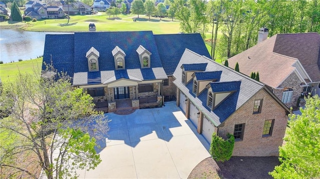 birds eye view of property featuring a water view and a residential view