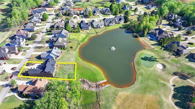 bird's eye view featuring a water view and a residential view