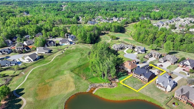 birds eye view of property with a residential view, a view of trees, view of golf course, and a water view
