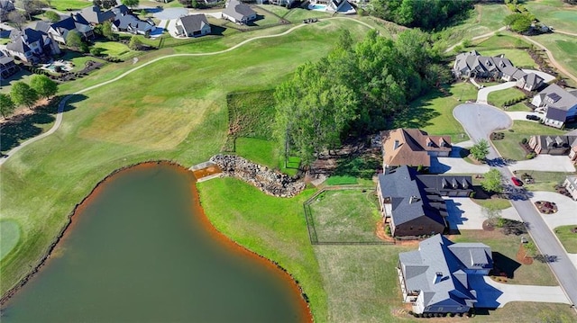 drone / aerial view featuring a residential view, view of golf course, and a water view